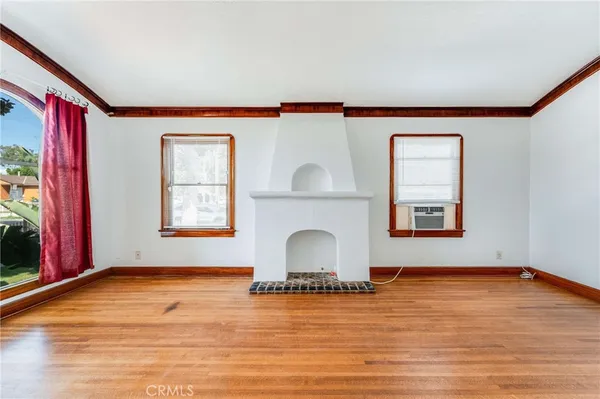 a room with a fireplace and wooden floor