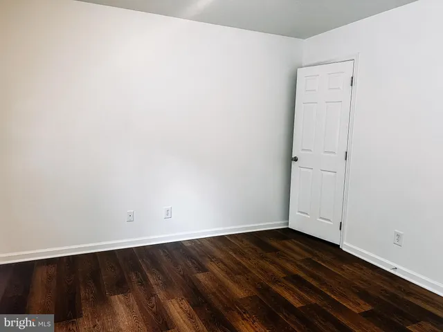an empty room with wooden floor