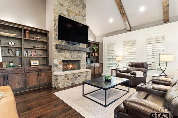 a view of a dining room with furniture and a chandelier