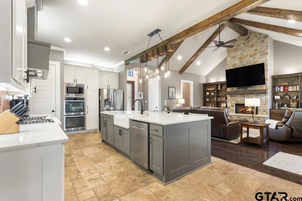 a bathroom with a granite countertop sink mirror and a bathtub