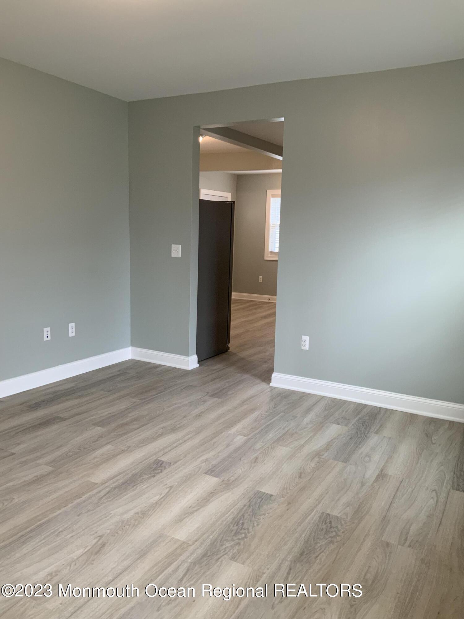 104 Bridge Avenue, Unit APARTMENT 1 Red Bank, NJ 07701 - Photo 13 of 25 a view of an empty room with wooden floor and closet