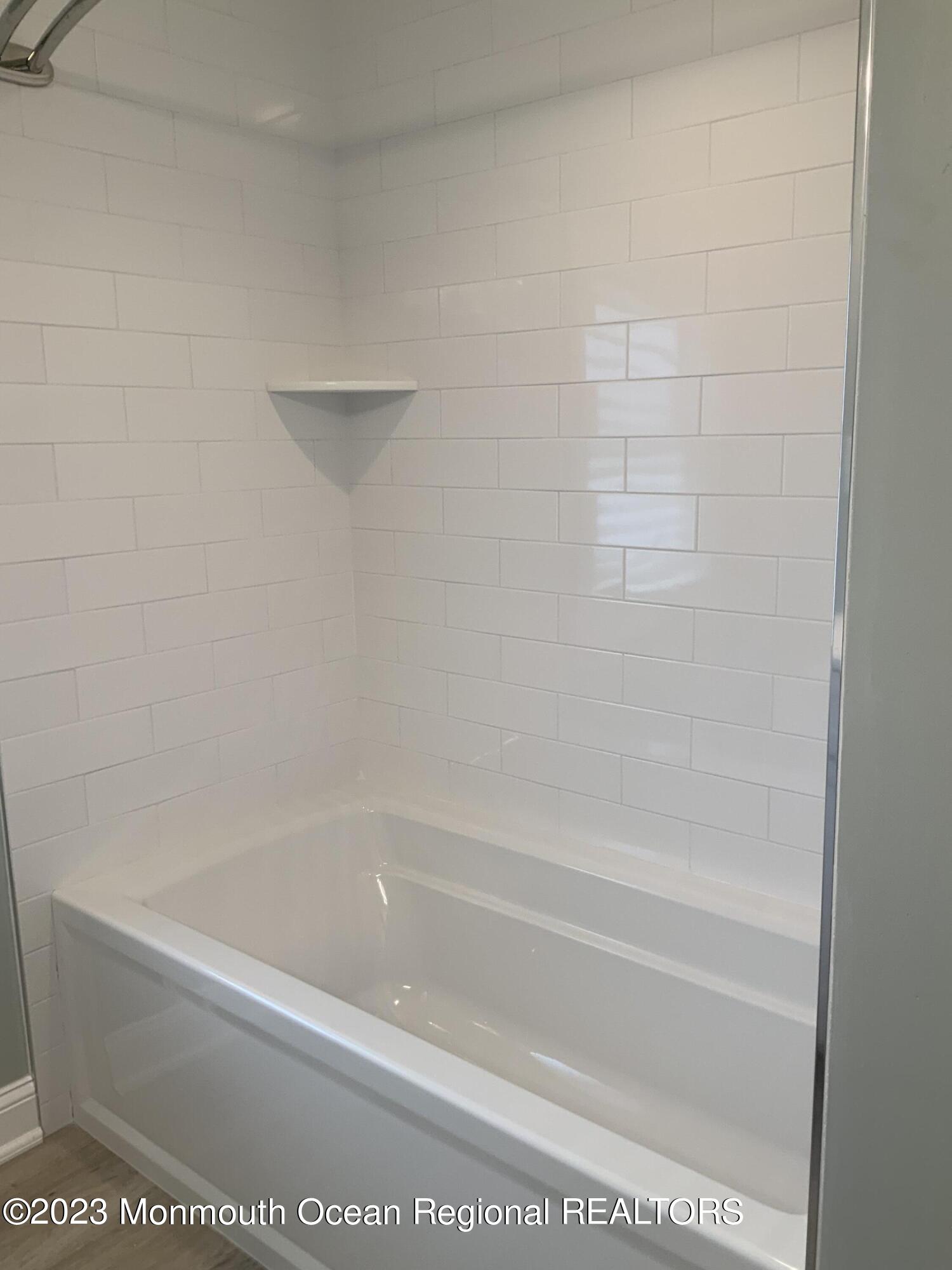 104 Bridge Avenue, Unit APARTMENT 1 Red Bank, NJ 07701 - Photo 20 of 25 a close up of a bathtub