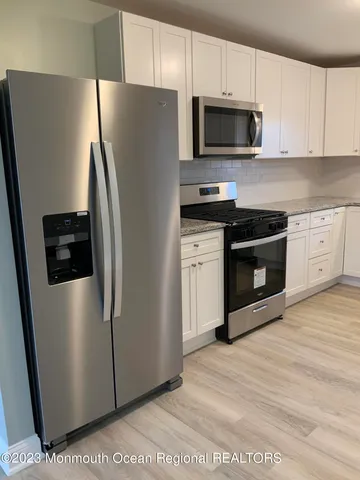 a kitchen with stainless steel appliances a refrigerator stove and microwave