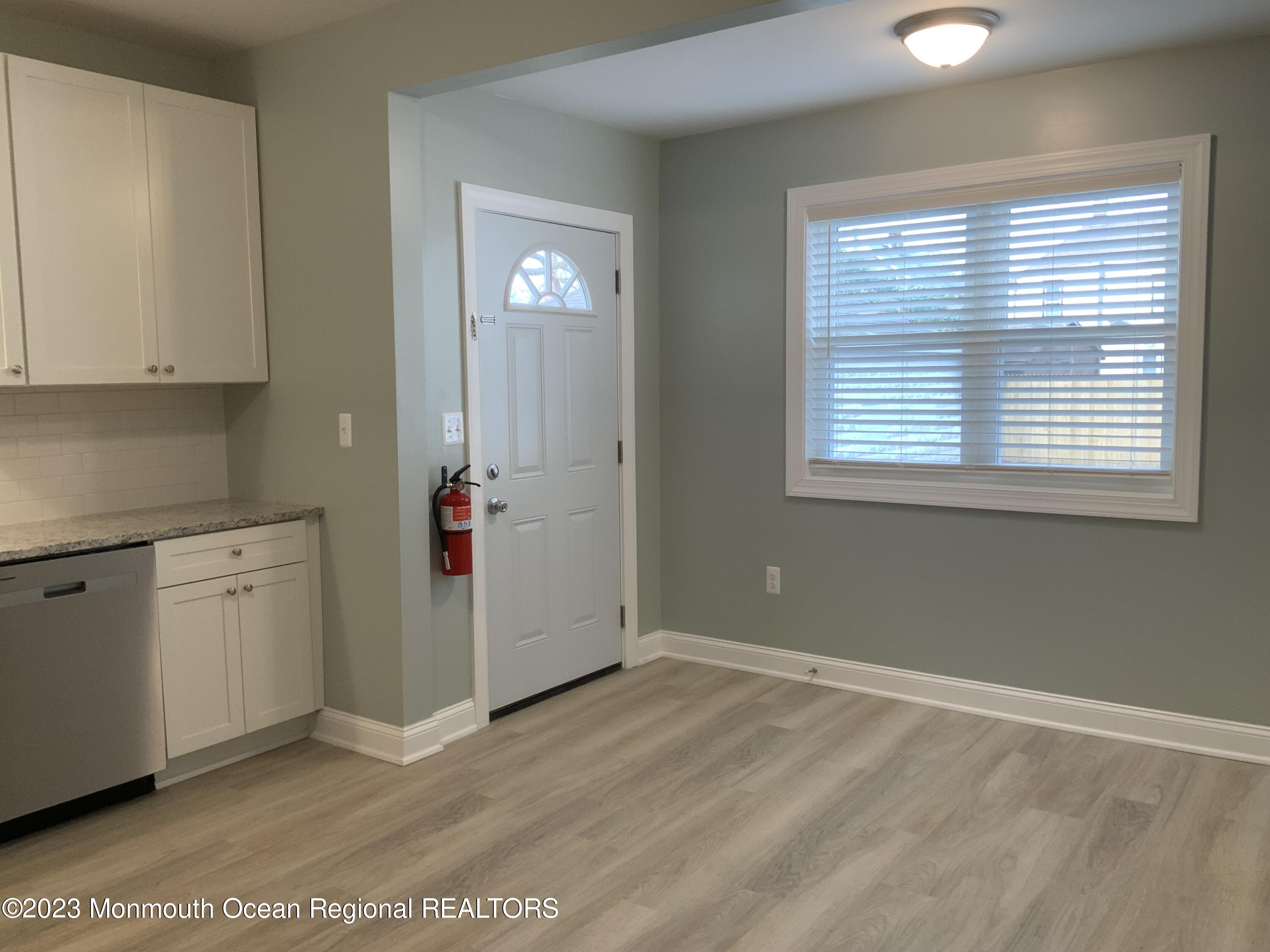 104 Bridge Avenue, Unit APARTMENT 1 Red Bank, NJ 07701 - Photo 8 of 25 a view of an empty room with window and cabinet