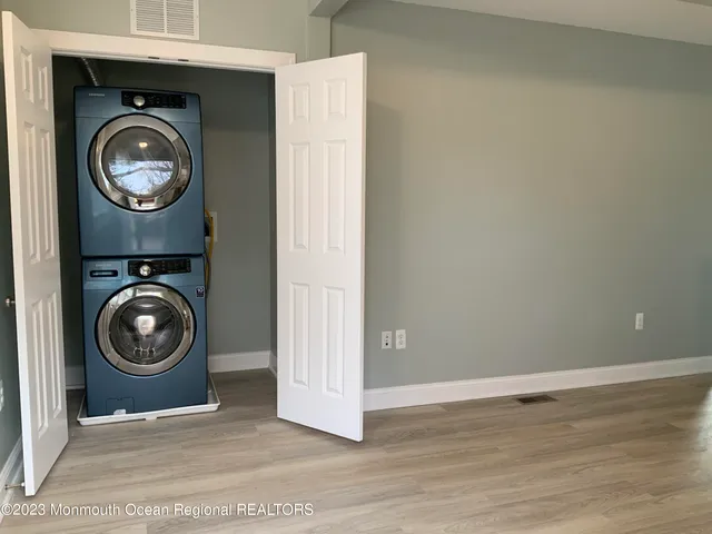 a view of a storage and utility room with washer and dryer