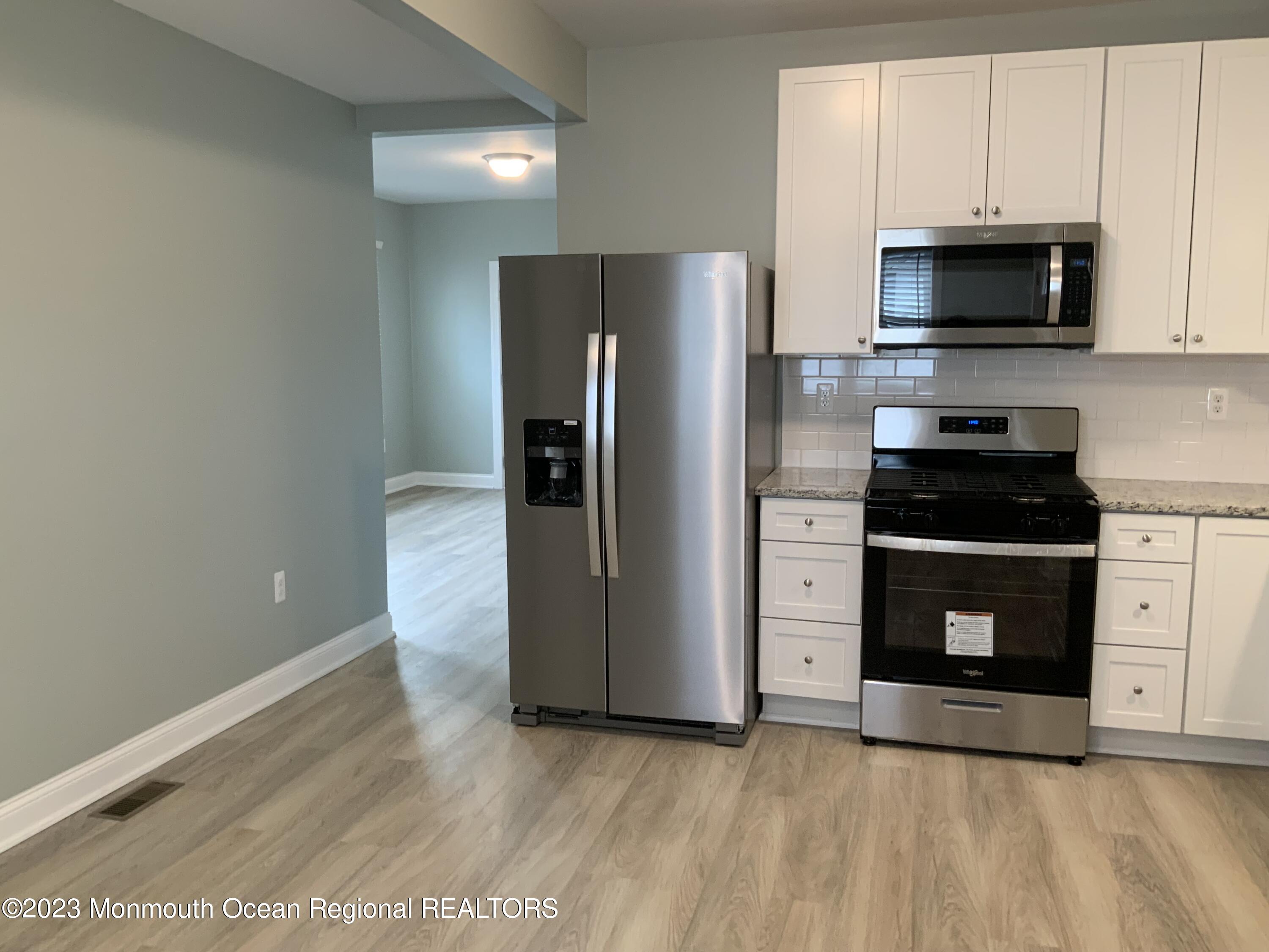 104 Bridge Avenue, Unit APARTMENT 1 Red Bank, NJ 07701 - Photo 10 of 25 a kitchen with stainless steel appliances a refrigerator a stove and microwave