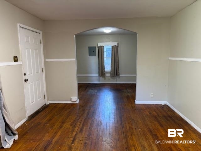 1809 Harris Road Mobile, AL 36618 - Photo 3 of 11 Spare room featuring arched walkways, dark wood-type flooring, and electric panel