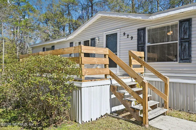 a living room with furniture fireplace and a large window