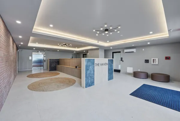 a living room with furniture and a chandelier