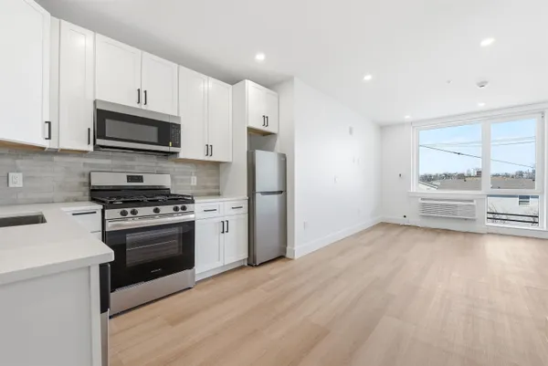 a kitchen with stainless steel appliances a stove a refrigerator and a sink