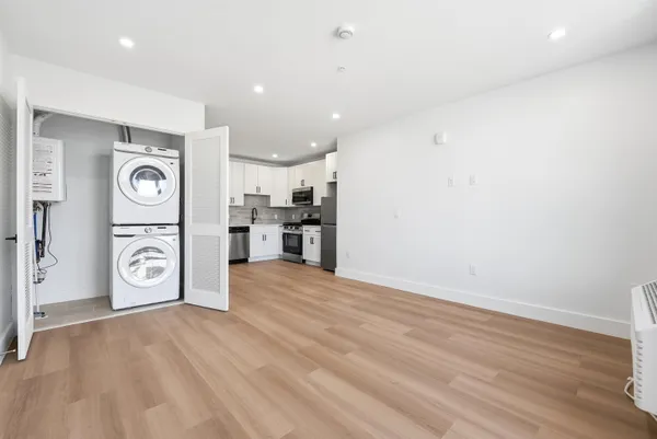 a view of a kitchen with a refrigerator a stove top oven