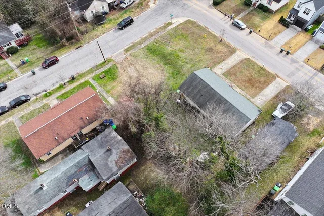 an aerial view of a house with a yard