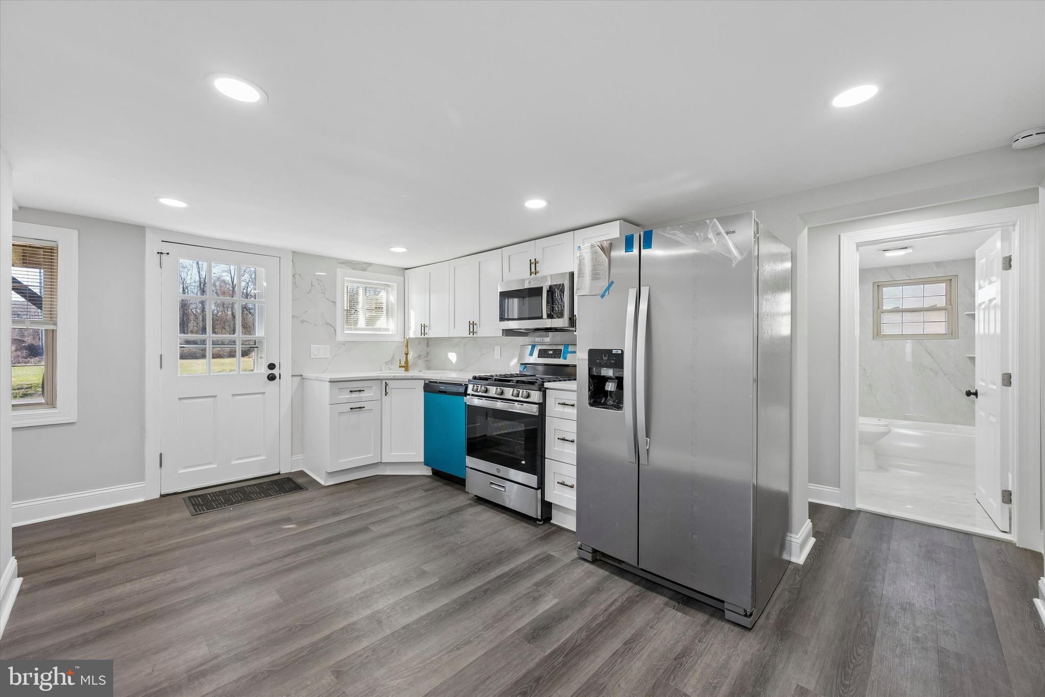 a kitchen with stainless steel appliances a refrigerator and a stove top oven