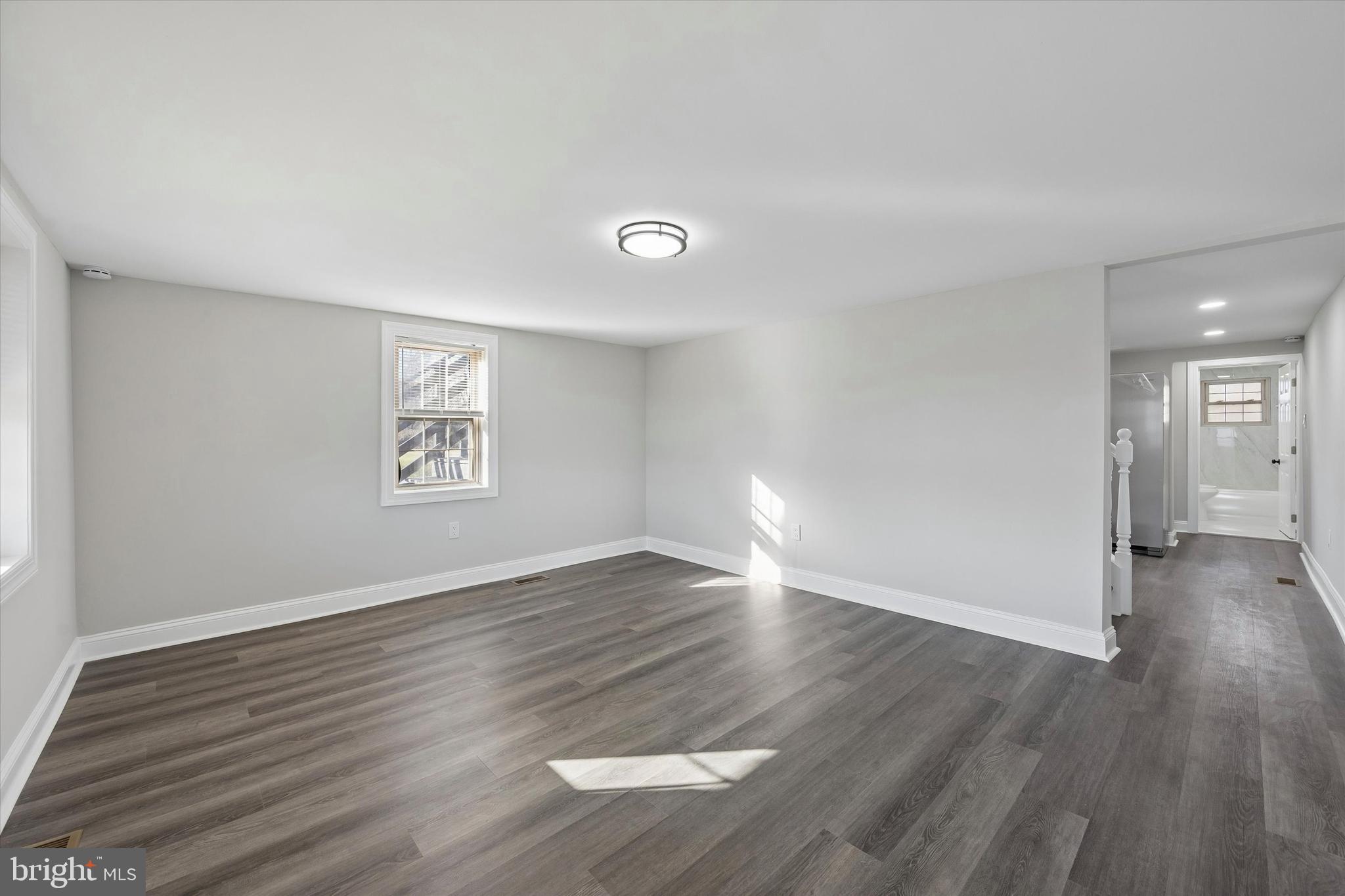 635 Stanton Christiana Road Newark, DE 19713 - Photo 5 of 12 an empty room with wooden floor and windows