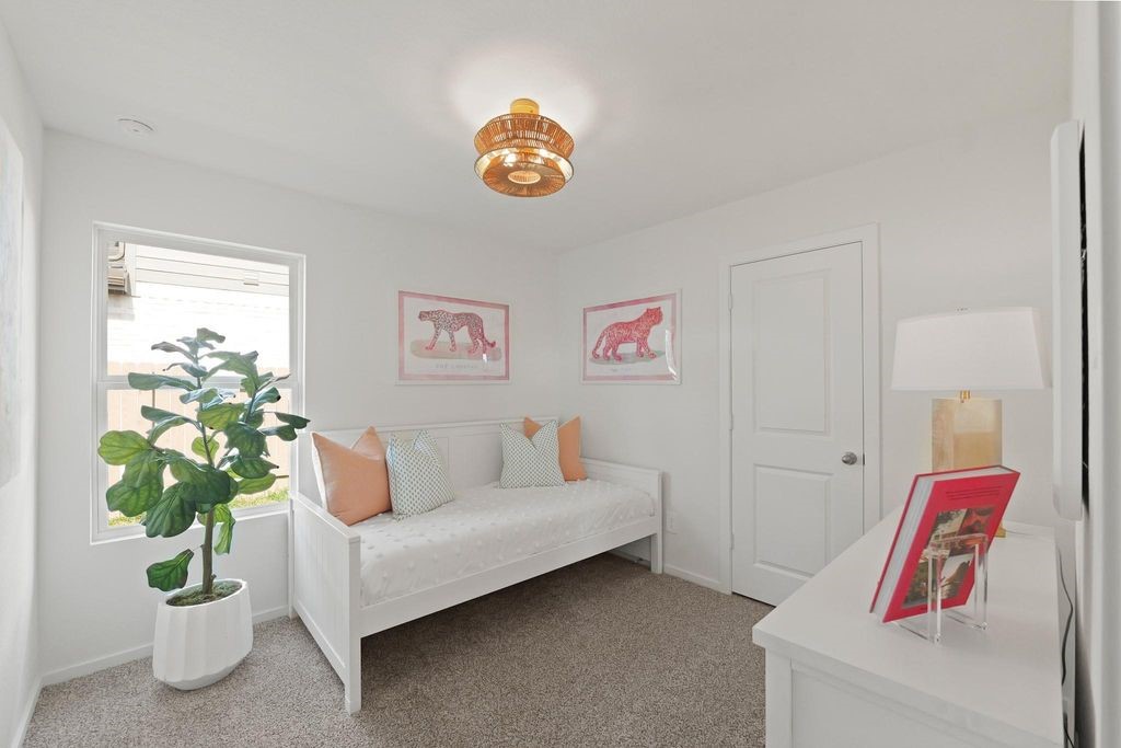 24114 Chirp Street Splendora, TX 77372 - Photo 13 of 22 a living room with furniture and a potted plant
