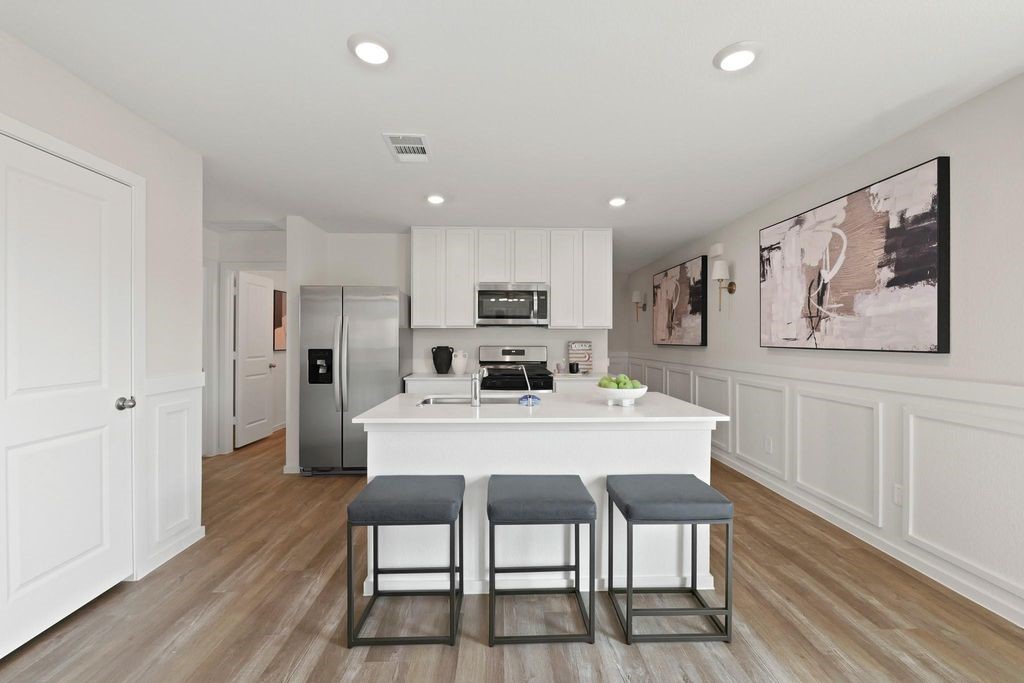24114 Chirp Street Splendora, TX 77372 - Photo 3 of 22 a view of a dining room with furniture and wooden floor