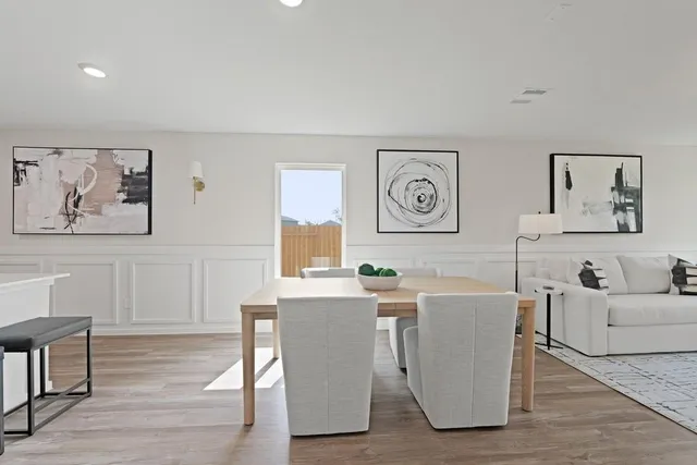 a living room with fireplace furniture and a wooden floor