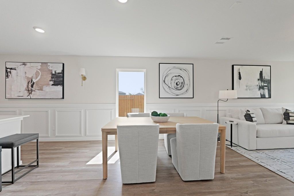 24114 Chirp Street Splendora, TX 77372 - Photo 6 of 22 a living room with furniture and paintings on the wall