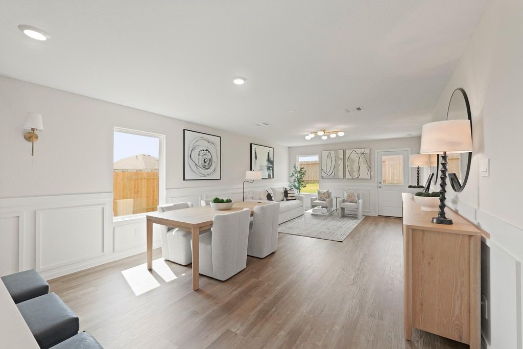 24114 Chirp Street Splendora, TX 77372 - Photo 7 of 22 a living room with fireplace furniture and a wooden floor