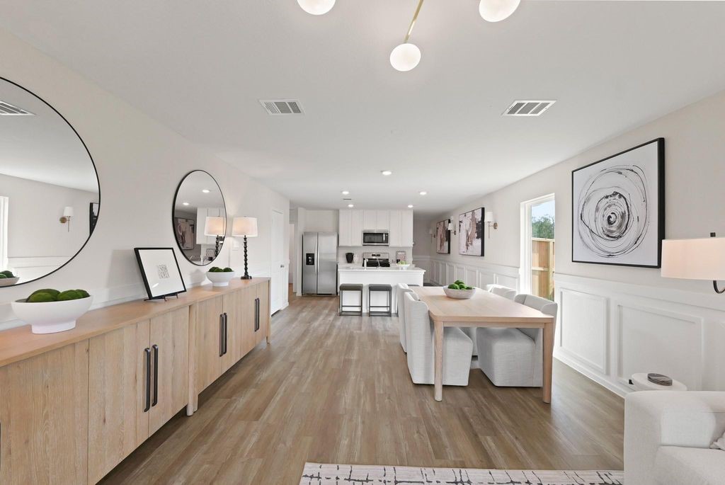 24114 Chirp Street Splendora, TX 77372 - Photo 9 of 22 a living room with furniture a wooden floor and a large window