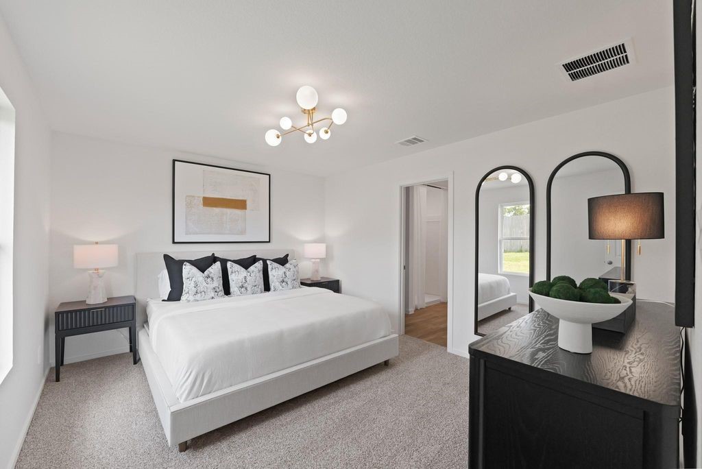 24114 Chirp Street Splendora, TX 77372 - Photo 10 of 22 a bedroom with a bed and a lamp