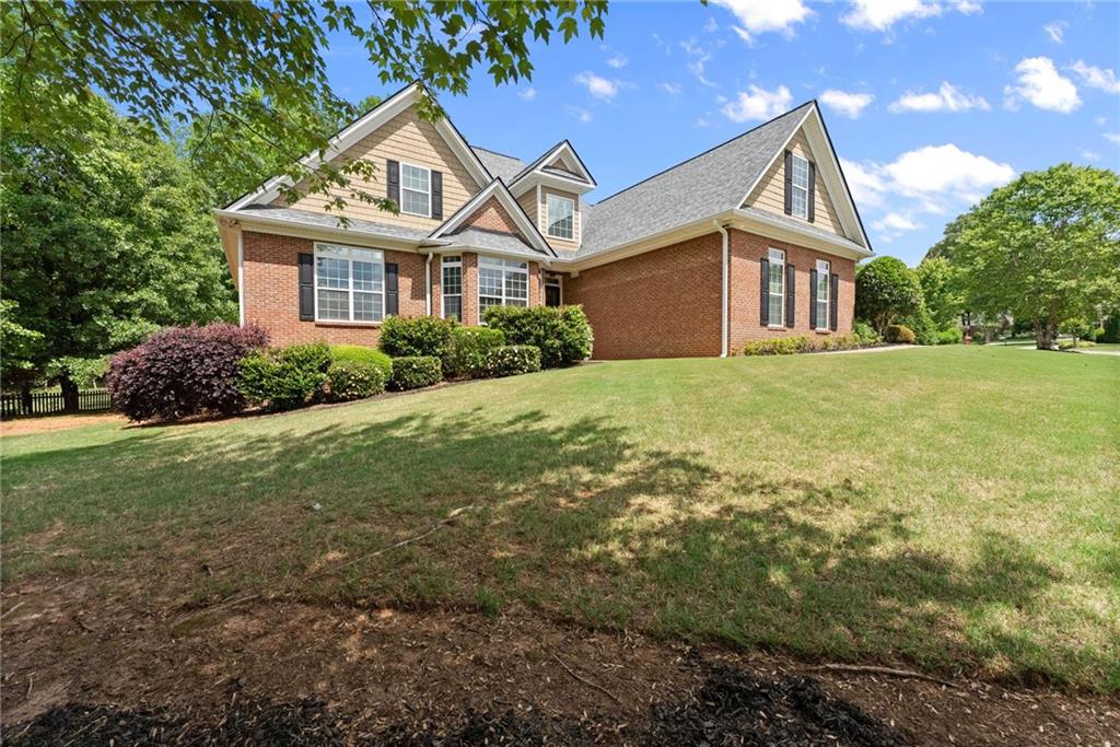 6643 Windvane Point Clermont, GA 30527 - Photo 84 of 88 a front view of a house with a garden