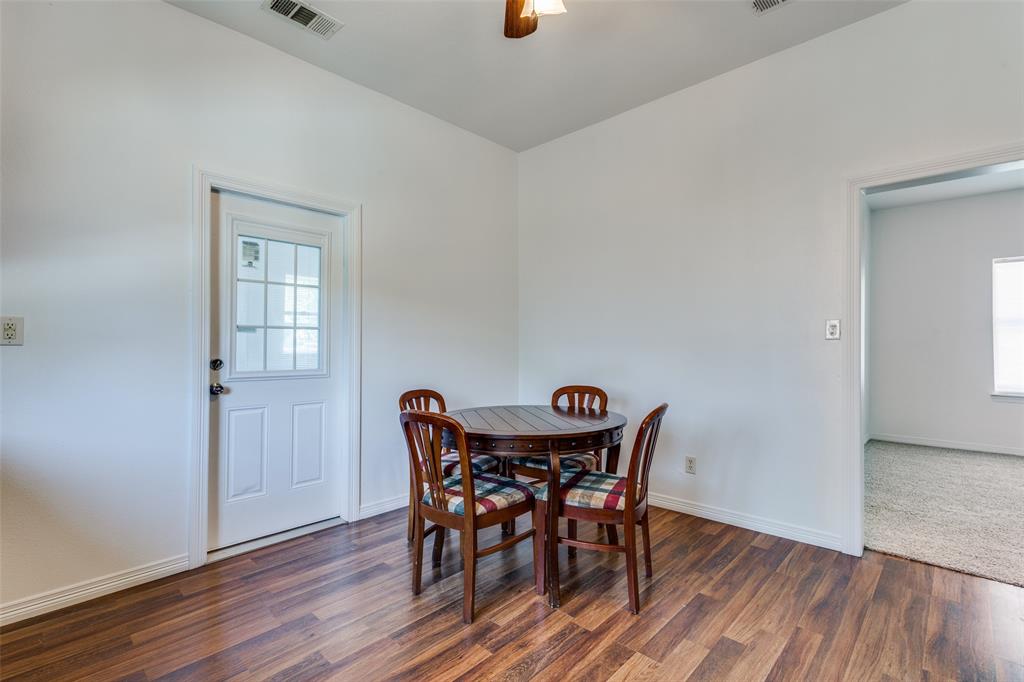 618 East Woodard Street Denison, TX 75021 - Photo 11 of 22 a view of a dining room with furniture and wooden floor