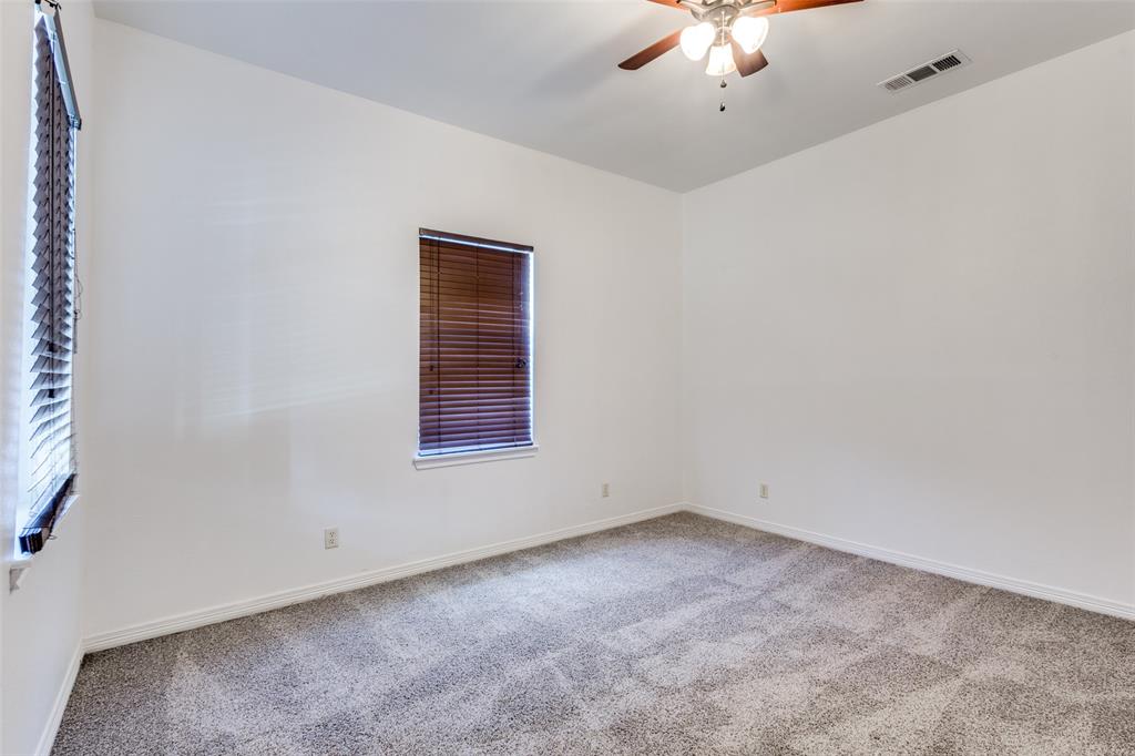 618 East Woodard Street Denison, TX 75021 - Photo 14 of 22 an empty room with a ceiling fan and a window