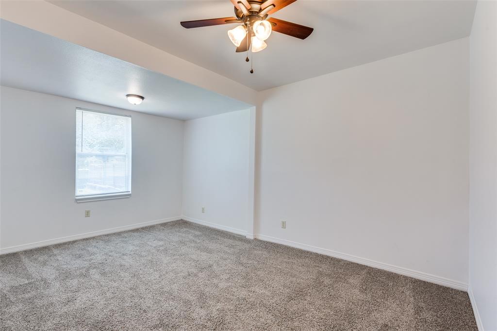 618 East Woodard Street Denison, TX 75021 - Photo 15 of 22 an empty room with a window and a fan