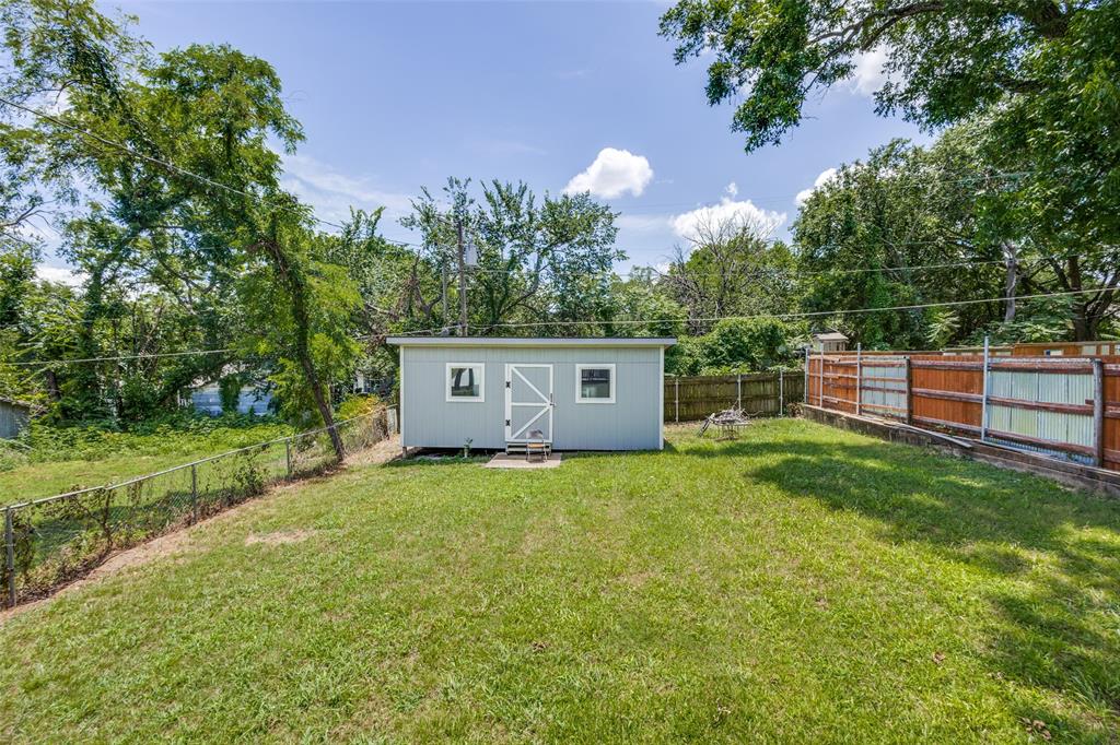 618 East Woodard Street Denison, TX 75021 - Photo 22 of 22 a view of a backyard with a garden and trees