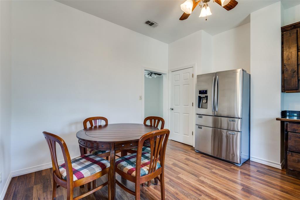 618 East Woodard Street Denison, TX 75021 - Photo 10 of 22 a kitchen with stainless steel appliances granite countertop a dining table and chairs