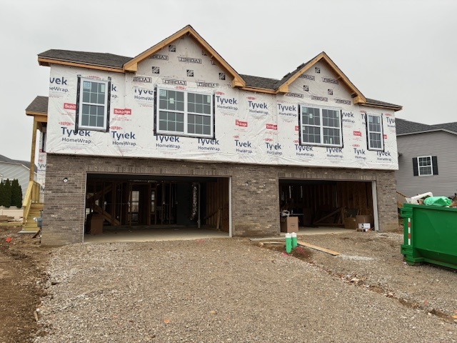a view of a white house with large windows and a yard