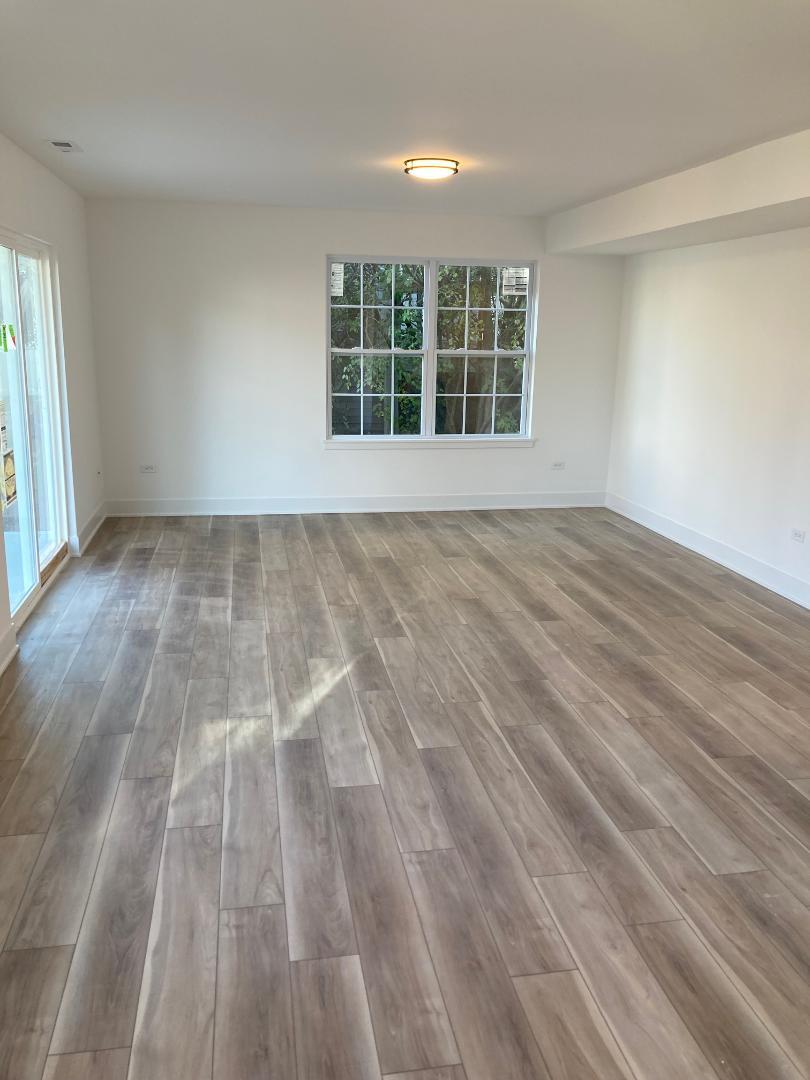 935 Saddle Ridge Drive Joliet, IL 60432 - Photo 16 of 21 wooden floor in an empty room with a window