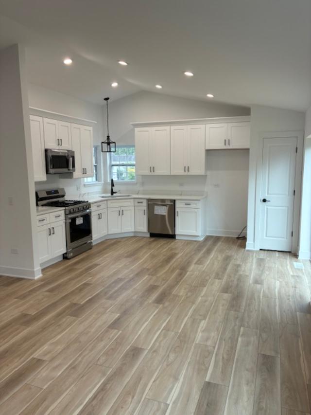 935 Saddle Ridge Drive Joliet, IL 60432 - Photo 4 of 21 a large kitchen with cabinets wooden floor and stainless steel appliances
