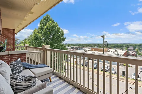 a view of a balcony with wooden floor