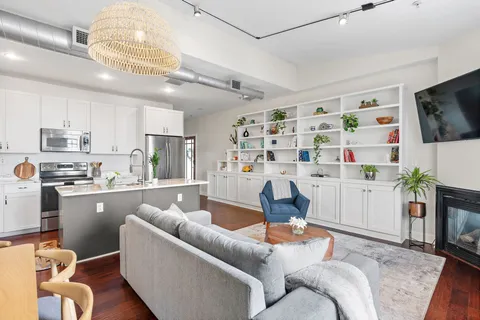 a living room with furniture and a kitchen view