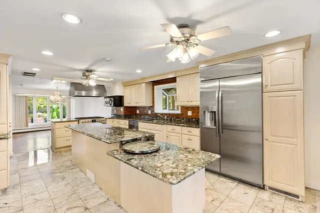 a kitchen with refrigerator and cabinets