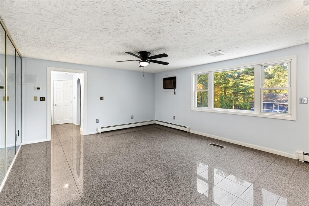 227 Walnut Street Saugus, MA 01906 - Photo 19 of 41 an empty room with windows and ceiling fan
