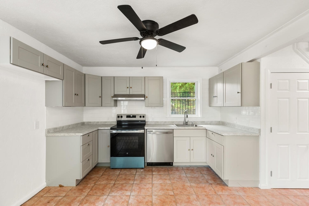227 Walnut Street Saugus, MA 01906 - Photo 30 of 41 a kitchen with cabinets stainless steel appliances and a window