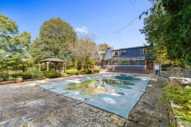 a view of a house with a yard and sitting area