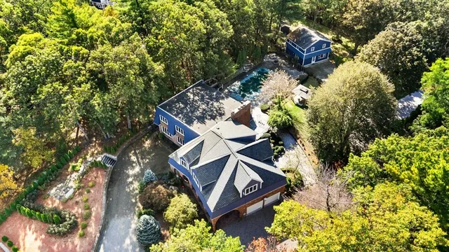 front view of a house with a yard and tree s