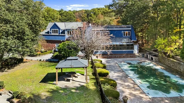 a swimming pool with outdoor seating and yard