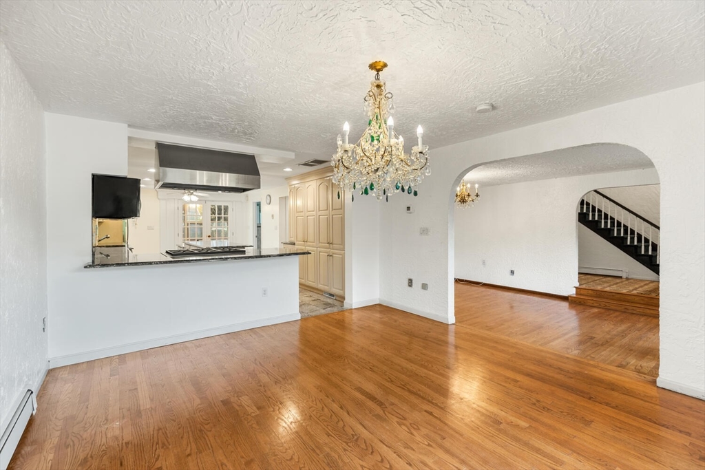 227 Walnut Street Saugus, MA 01906 - Photo 8 of 41 a view of a kitchen with wooden floor and a refrigerator
