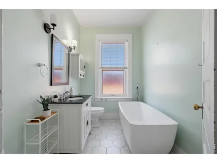 a bathroom with a sink a toilet and mirror