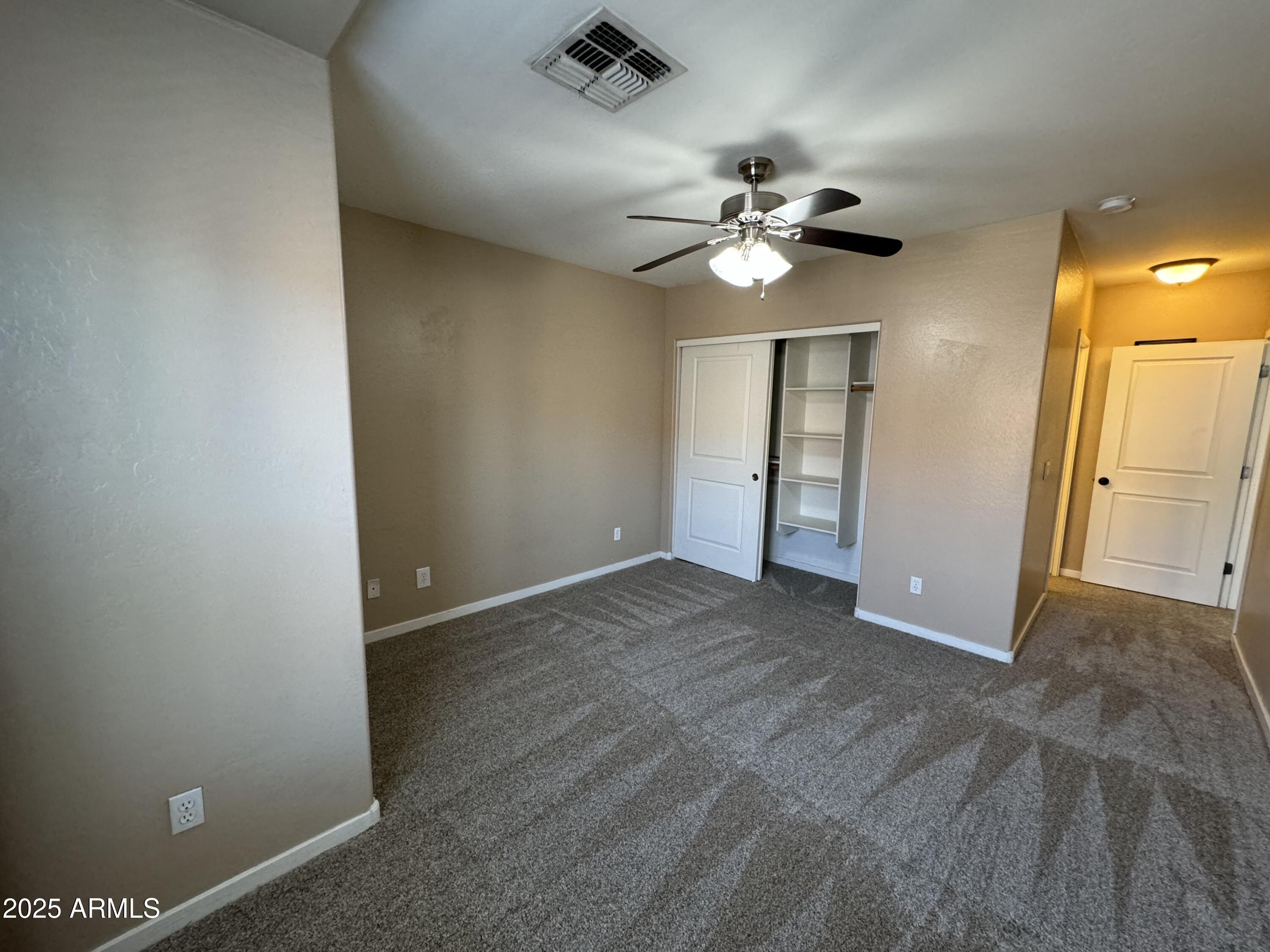 305 South Wilson Street, Unit 111 Tempe, AZ 85281 - Photo 34 of 48 an empty room with closet and a chandelier fan