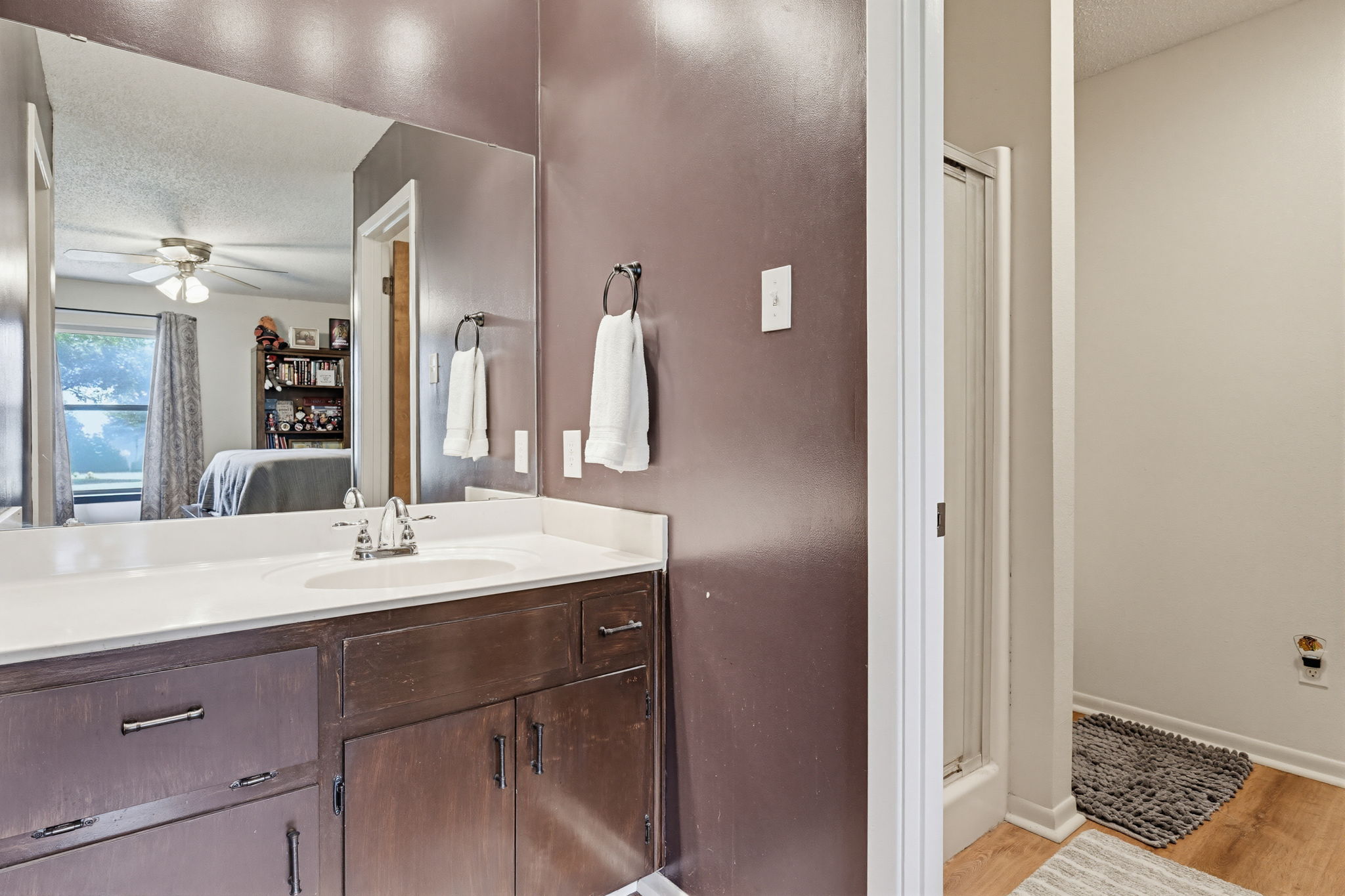 120 Rae Lane Jarrell, TX 76537 - Photo 32 of 40 Bathroom vanity with a built-in sink, white countertop, and dark wood cabinetry