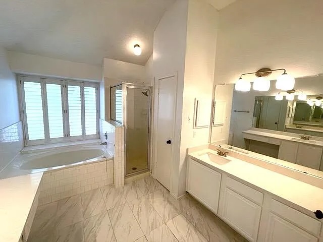 4410 Sojourner Street Austin, TX 78724 - Photo 12 of 15 a spacious bathroom with a tub sink and mirror