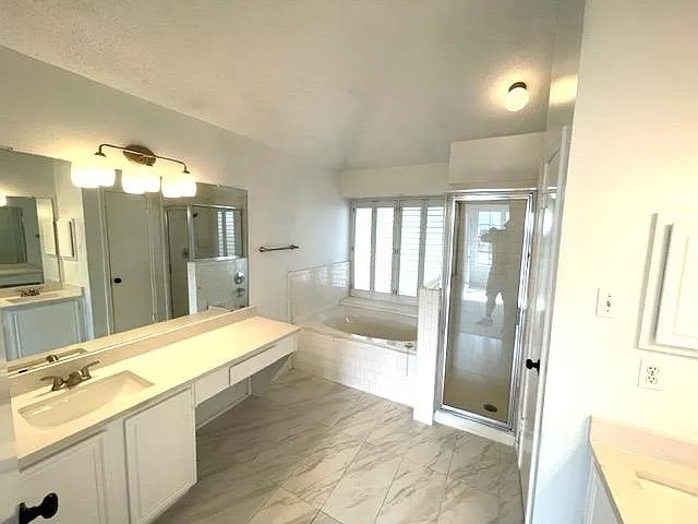 4410 Sojourner Street Austin, TX 78724 - Photo 13 of 15 a bathroom with a double vanity sink mirror and shower
