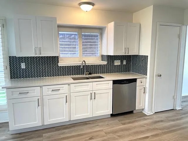4410 Sojourner Street Austin, TX 78724 - Photo 3 of 15 a kitchen with granite countertop white cabinets and sink
