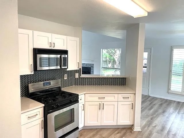 4410 Sojourner Street Austin, TX 78724 - Photo 4 of 15 a kitchen with white cabinets and appliances